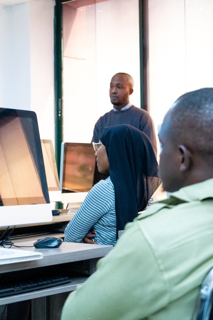 contact-img Students engaging in coding at a modern computer lab with a focus on ICT skills.